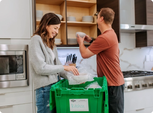 Woman and man standing next to a green box from 'A SMART Move'