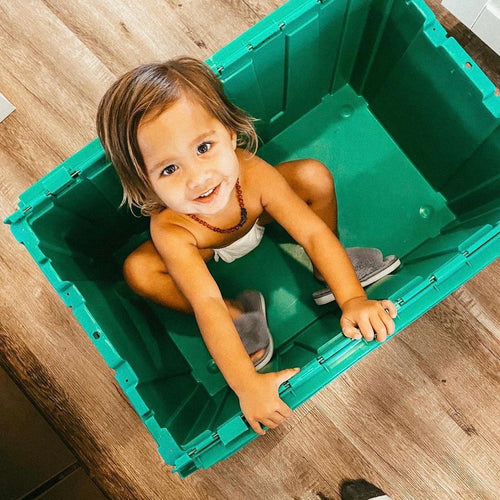 Happy child playing with A Smart Move Green Crates